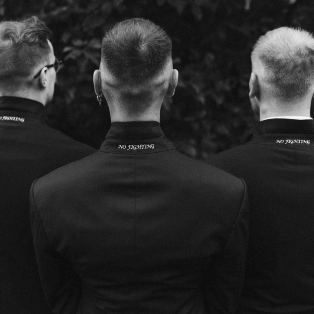Groomsmen in black grandad-collar jackets with embroidered detail